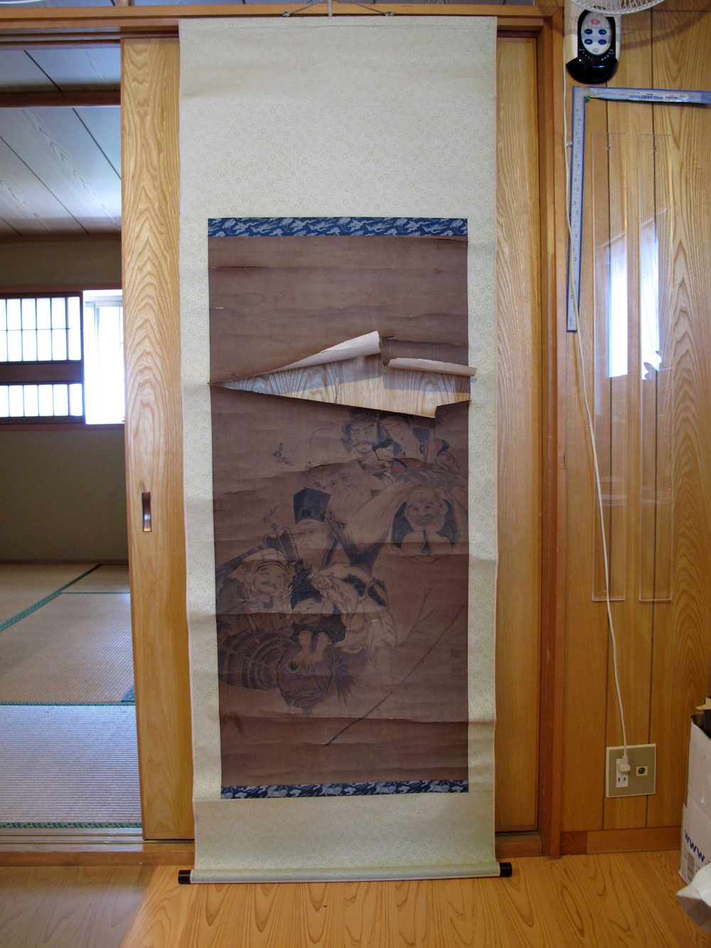 大きく破れた七福神の掛軸